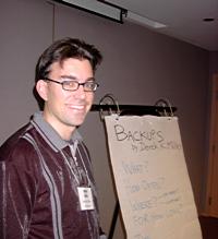 [Derek smiles by the flip chart]