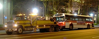 [A big truck towing a bus]