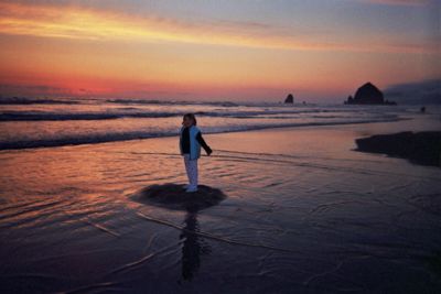 [Dancing daughter and Haystack Rock at sunset]