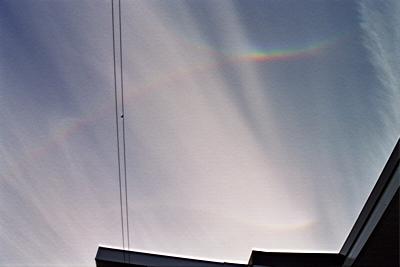 [Rainbows/sundogs in contact and bending in the sky]