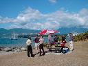 [Office on the beach with ocean, skyline, and sailboat in background - click for larger version]